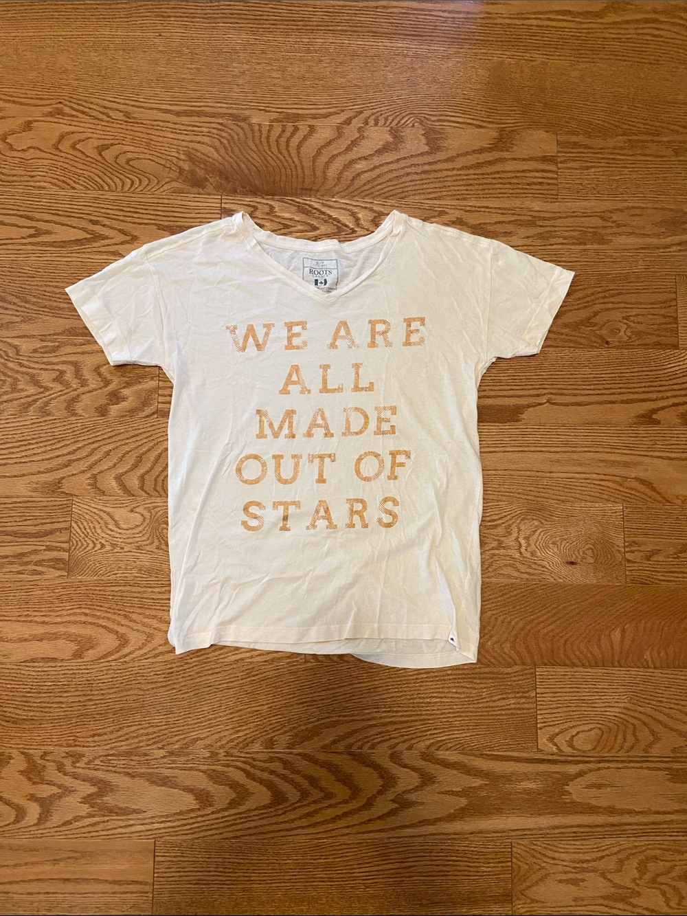 Roots ivory tee with Peach Lettering - "We Are All Made Out Of Stars" size small